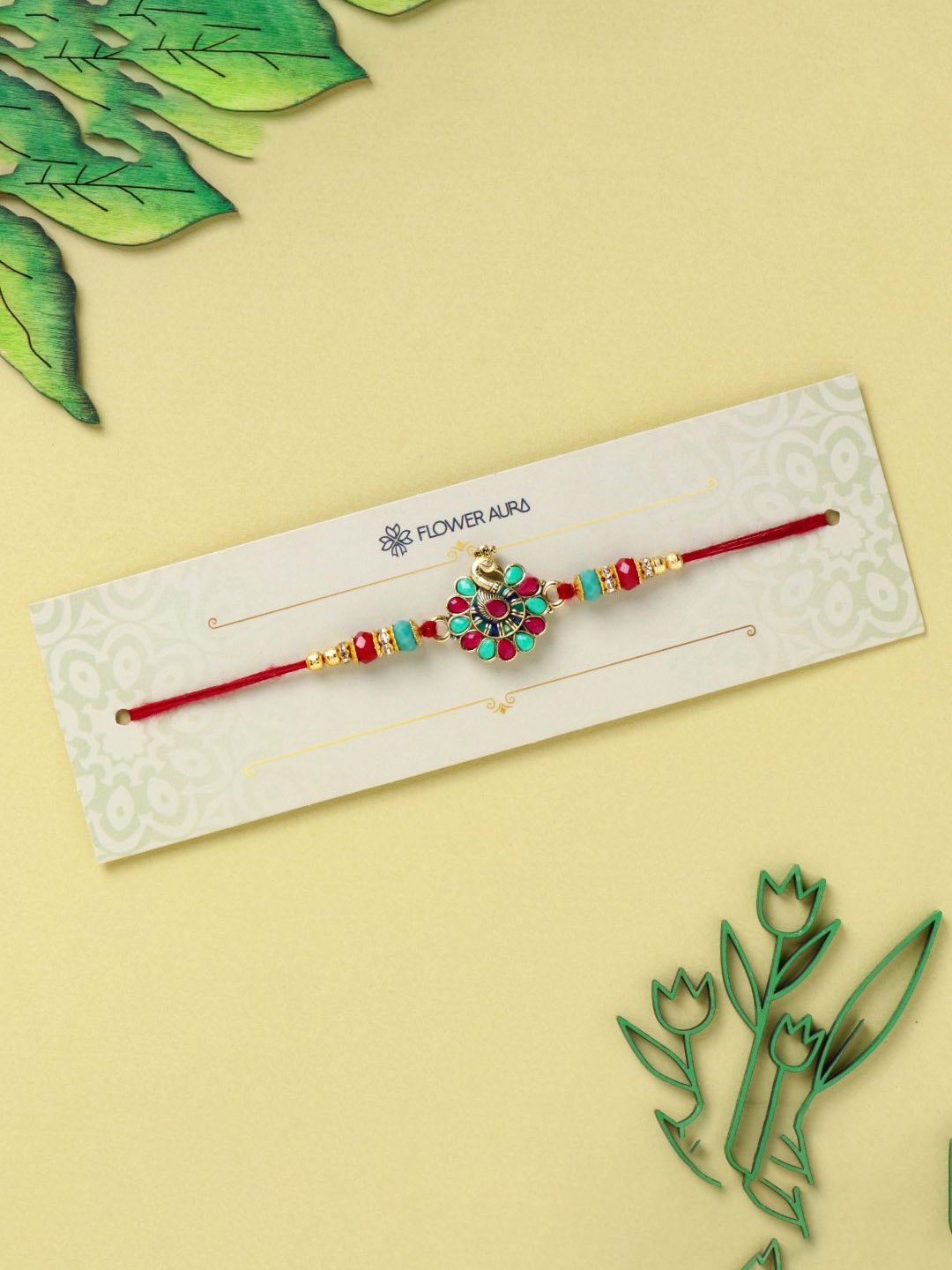 

Floweraura Beaded Peacock Charm Thread Rakhi With Roli Chawal, Red