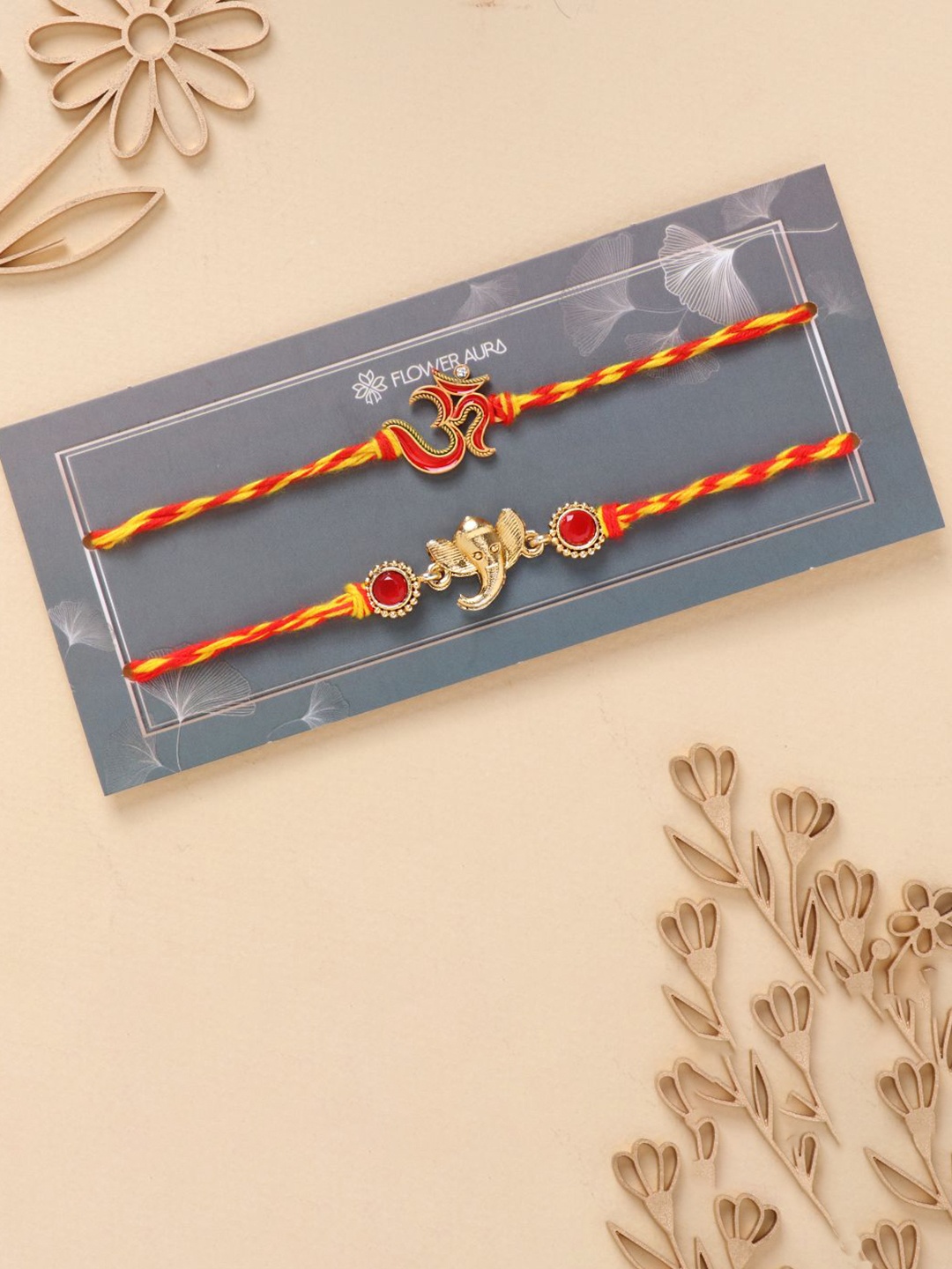 

Floweraura Set Of 2 Divine Om and Ganesha Thread Rakhis With Roli Chawal, Yellow