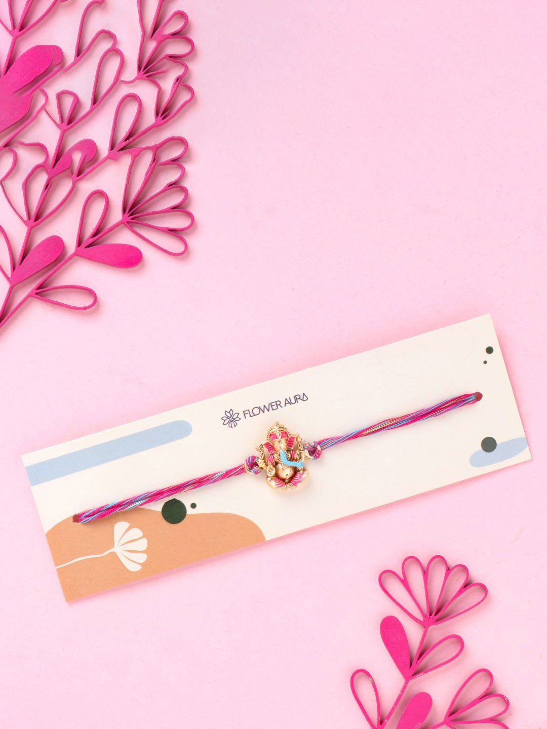 

Floweraura Divine Ganesha Thread Rakhi With Roli Chawal, Pink