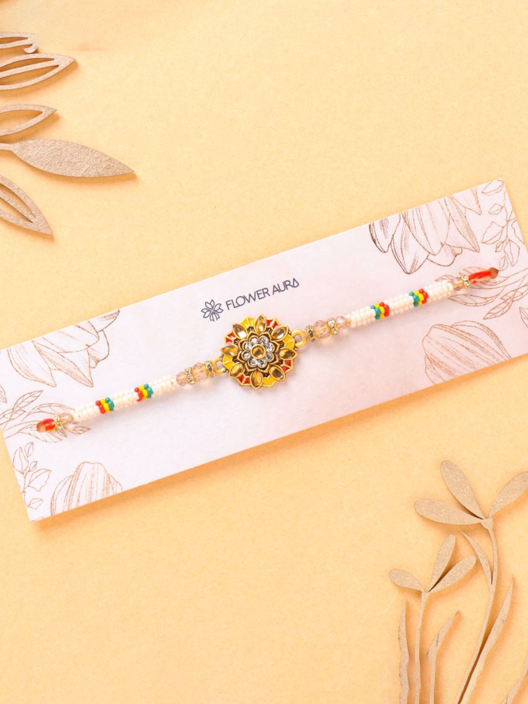 

Floweraura Meenakari Pearl Beaded Thread Rakhi With Roli Chawal, White