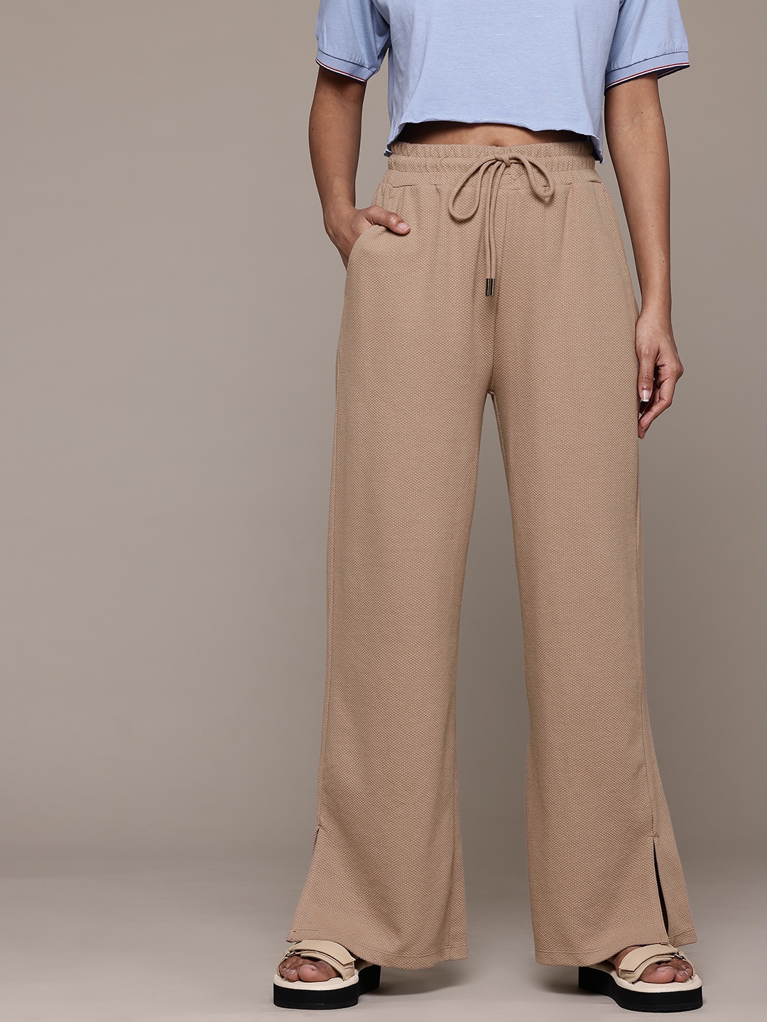 

The Roadster Lifestyle Co. Women Textured Flared Pleated Trousers, Beige