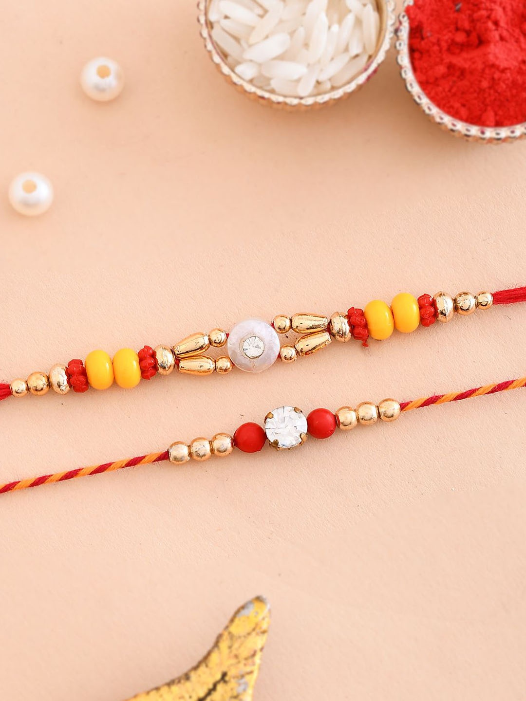 

Aapno Rajasthan Set Of 2 Pearl Beaded Rakhi With Roli Chawal & Card, Gold