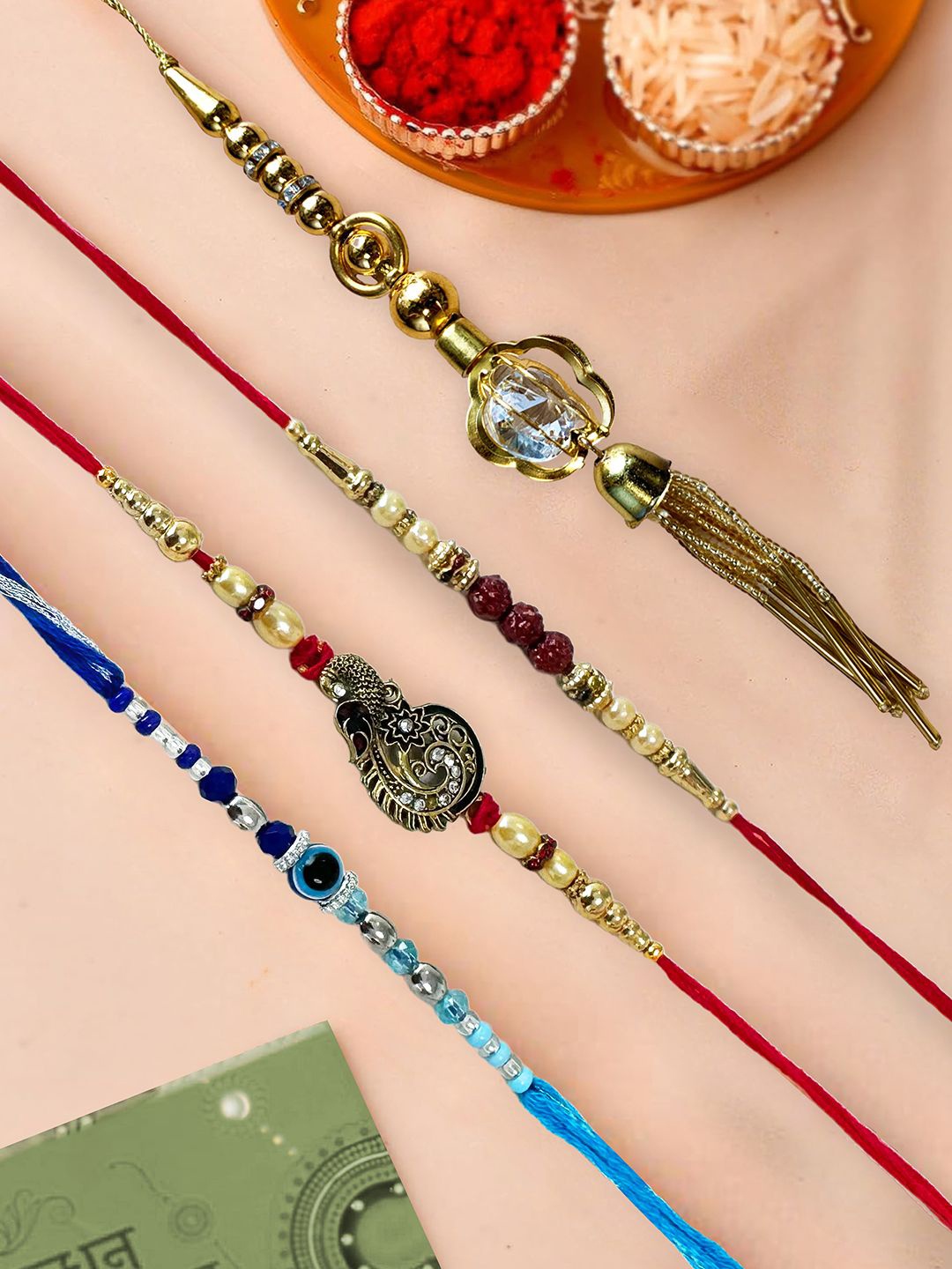 

Art Street Set Of 4 One Peacock Evil Eye Mauli & Lumba Thread Rakhi With Roli & Chawal, Blue