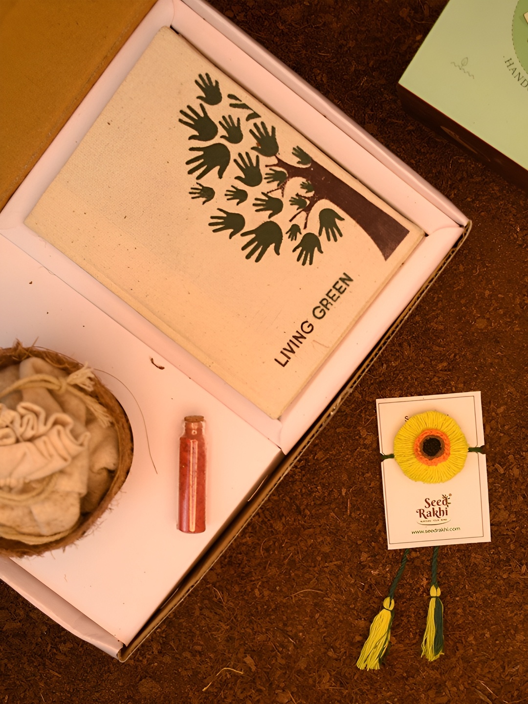 

Indigifts Seed Rakhi With Planter Dairy & Pen, Yellow