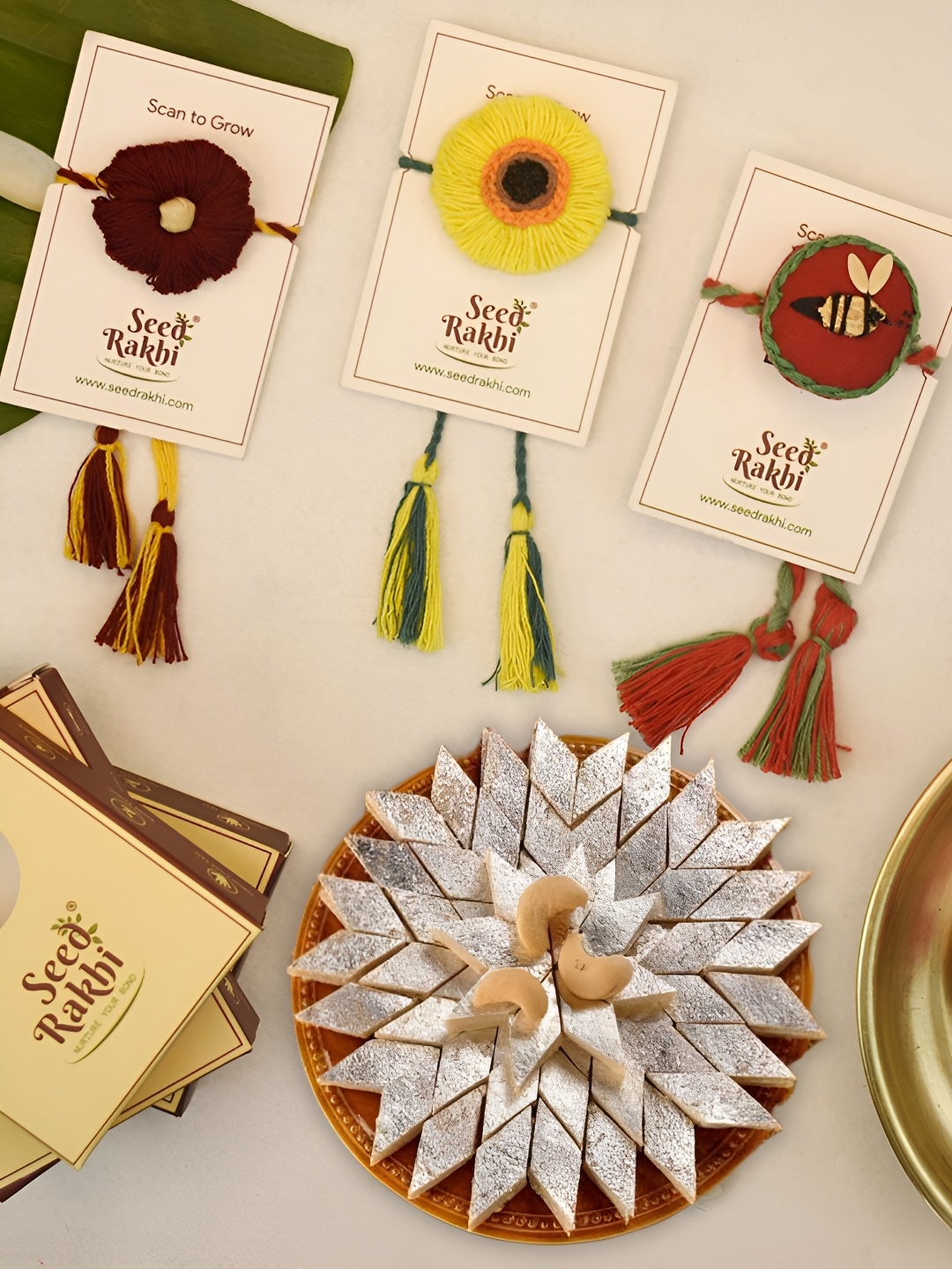 

Indigifts Set Of 4 Plantable Rakhis & Kaju Katlli Box, Yellow