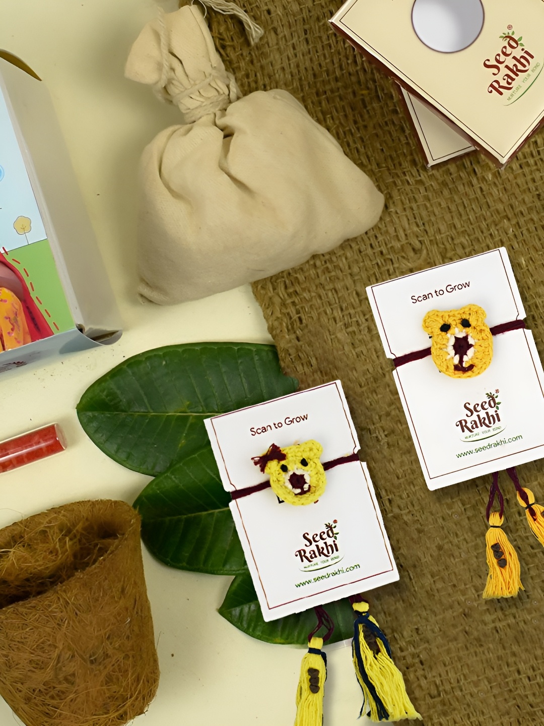 

Indigifts Set of 2 Plantable Rakhi & 1 Instruction Manual With Roli, Yellow