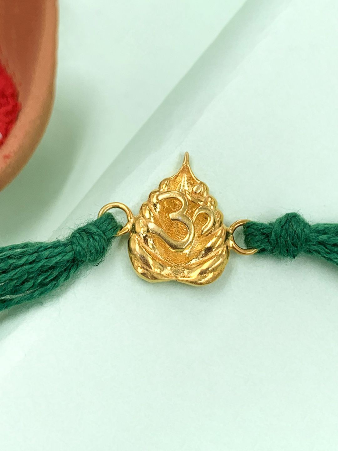 

Unniyarcha 92.5 Sterling Silver Gold Plated OM Thread Rakhi