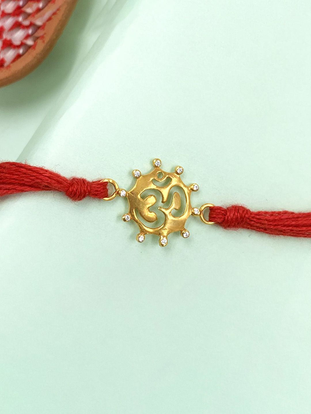 

Unniyarcha Sterling Silver Gold plated Om Thread Rakhi