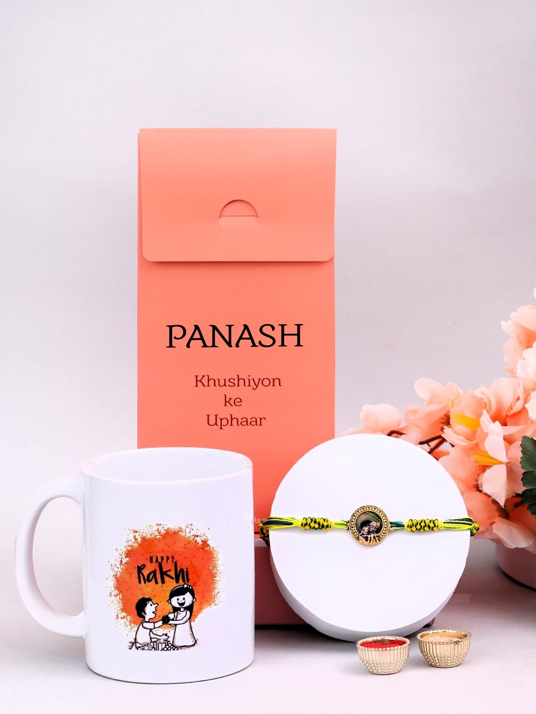 

PANASH Gold-Plated Rakhi With Gift Set Of Printed Mugs & Roli Chawal