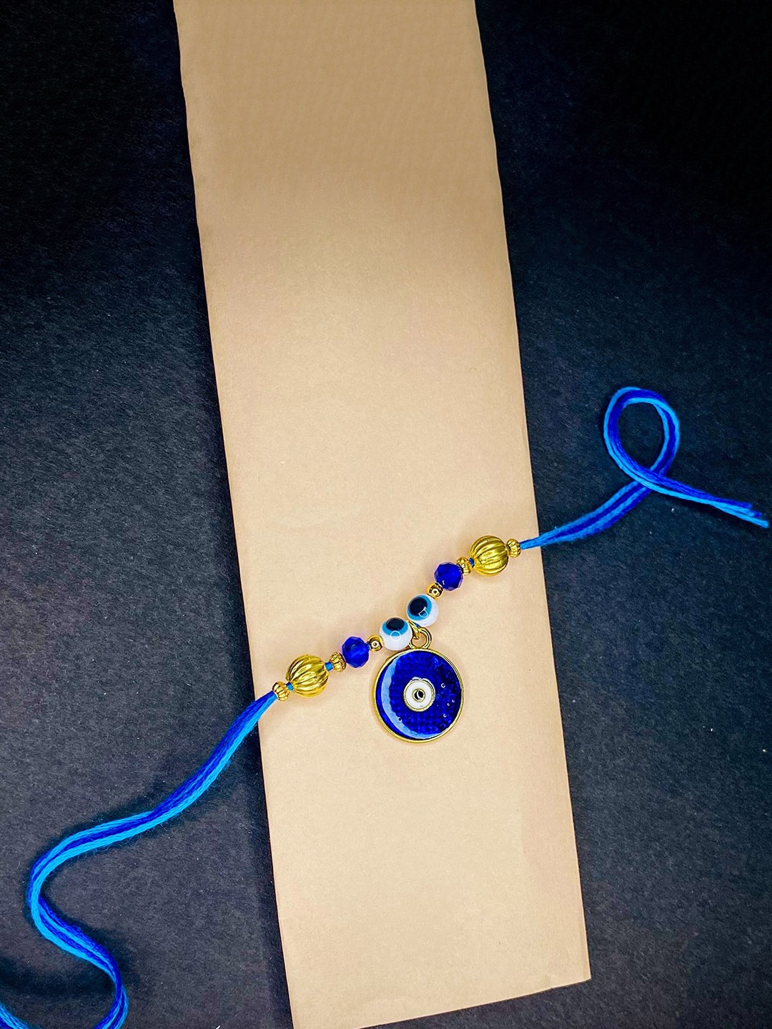 

Mahi Evil Eye Meenakari Work Thread Rakhi, Blue