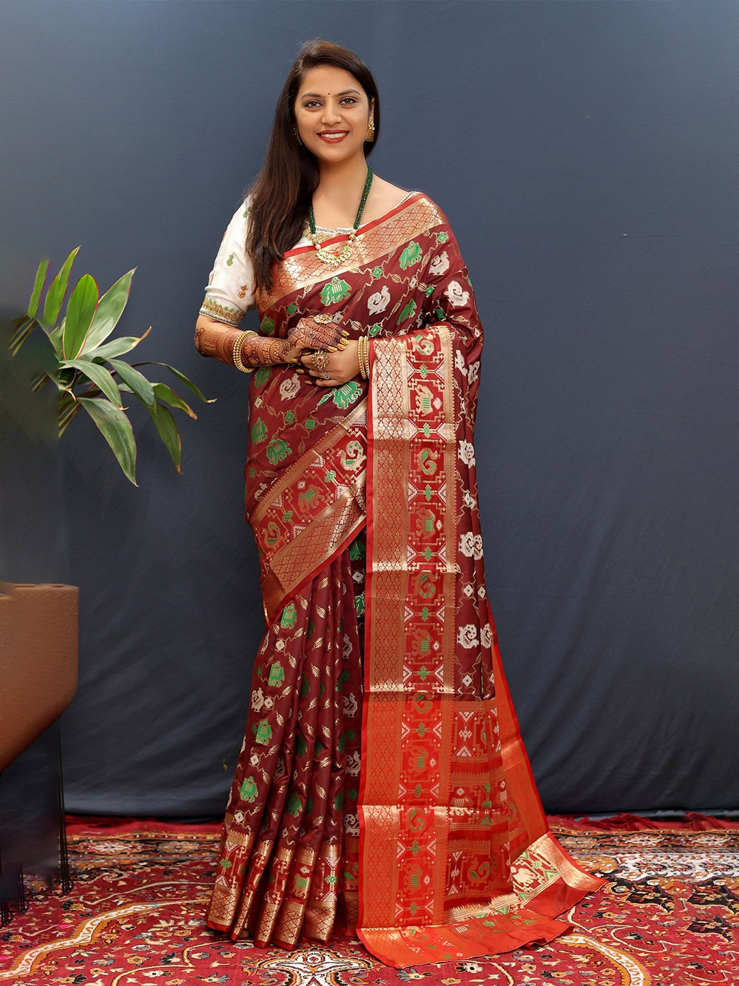 

Mitera Ethnic Motifs Woven Designed Zari Patola Saree, Maroon