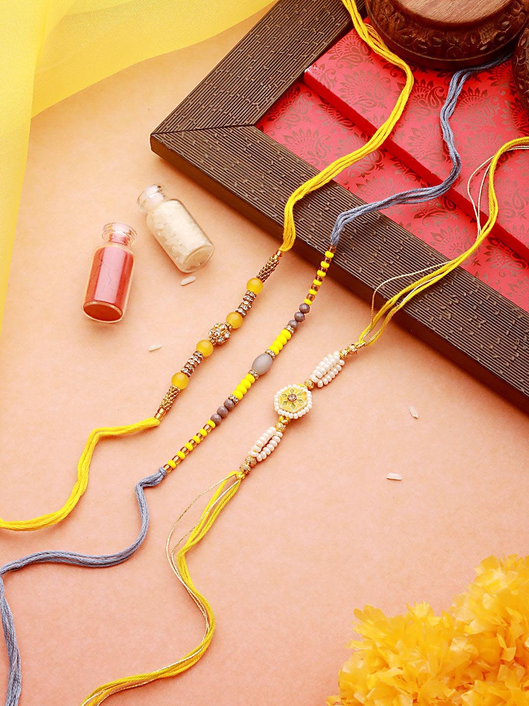 

Jazz and Sizzle Set of 3 Faux Pearls Beaded Thread Rakhi with Roli & Chawal, Yellow