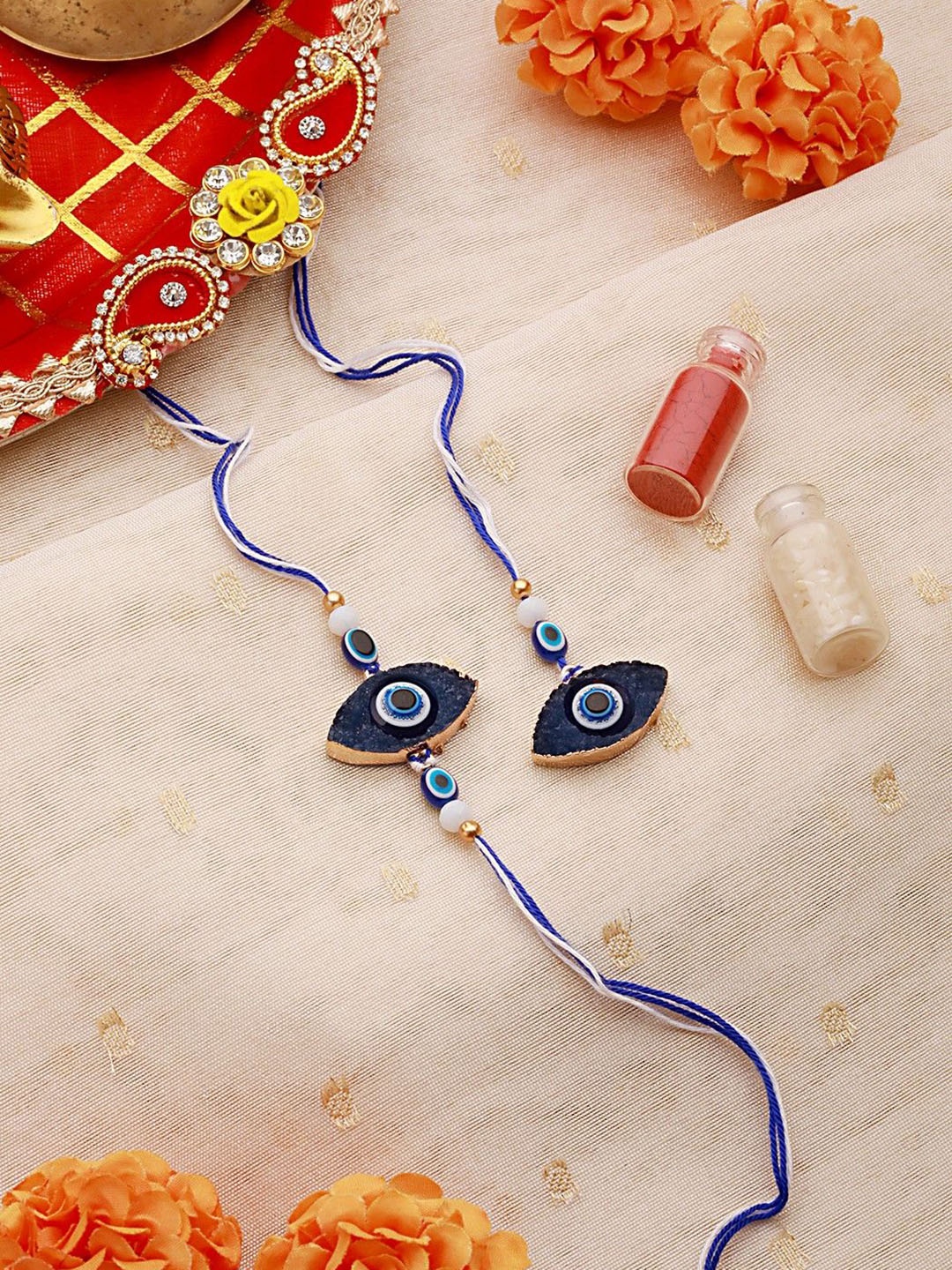 

Jazz and Sizzle Unisex Evil Eye Charm Bhaiya Bhabhi Rakhis with Roli & Chawal, Blue