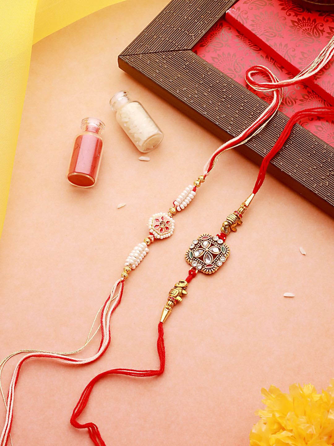 

Jazz and Sizzle Set Of 2 Beaded Thread Rakhis with Roli Chawal, Gold