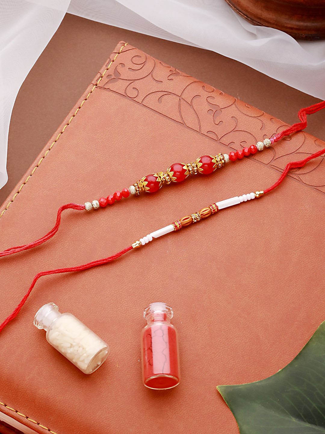 

Jazz and Sizzle Set of 2 Faux Pearl Beaded Thread Rakhi With Roli Chawal, Maroon