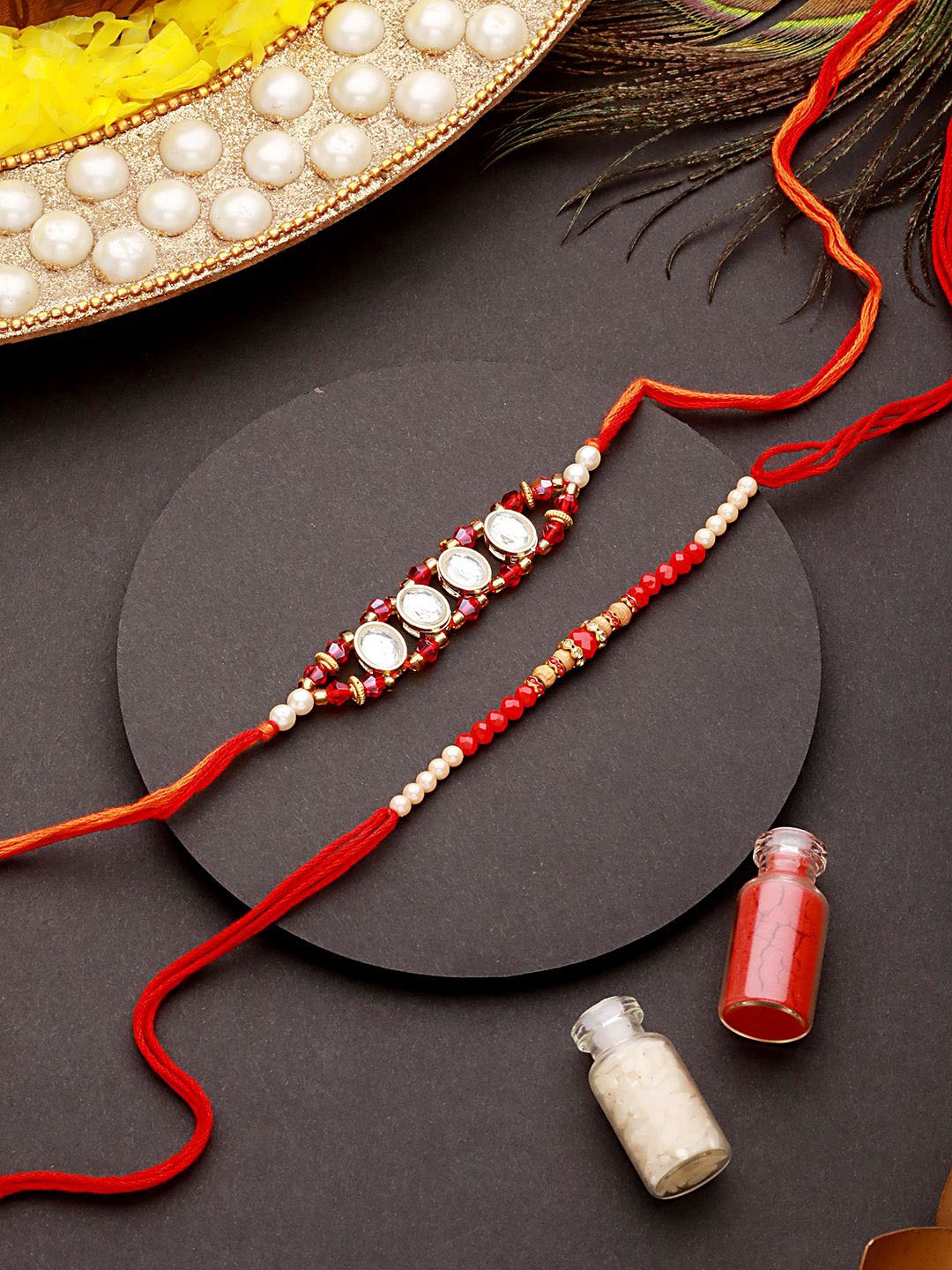 

Jazz and Sizzle Set of 2 Kundan Studded & Faux Pearl Beaded Thread Rakhi With Roli Chawal, Maroon