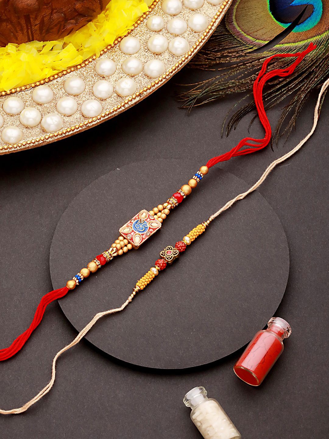 

Jazz and Sizzle Set of 2 Om & Rudraksh Thread Rakhi with Roli Chawal, Gold