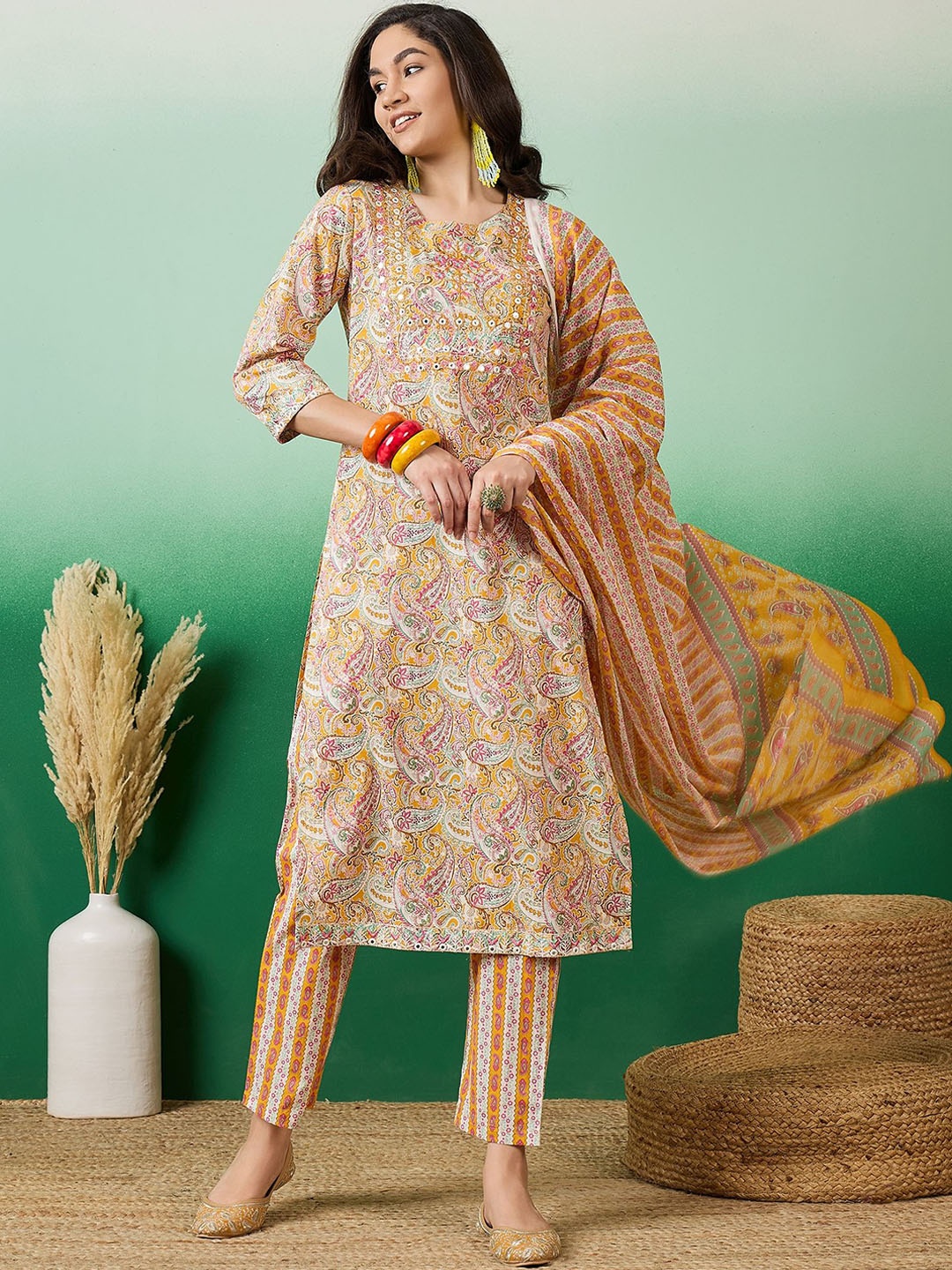 

Vastramyaa Paisley Printed Thread Work Pure Cotton Straight Kurta With Trousers & Dupatta, Mustard