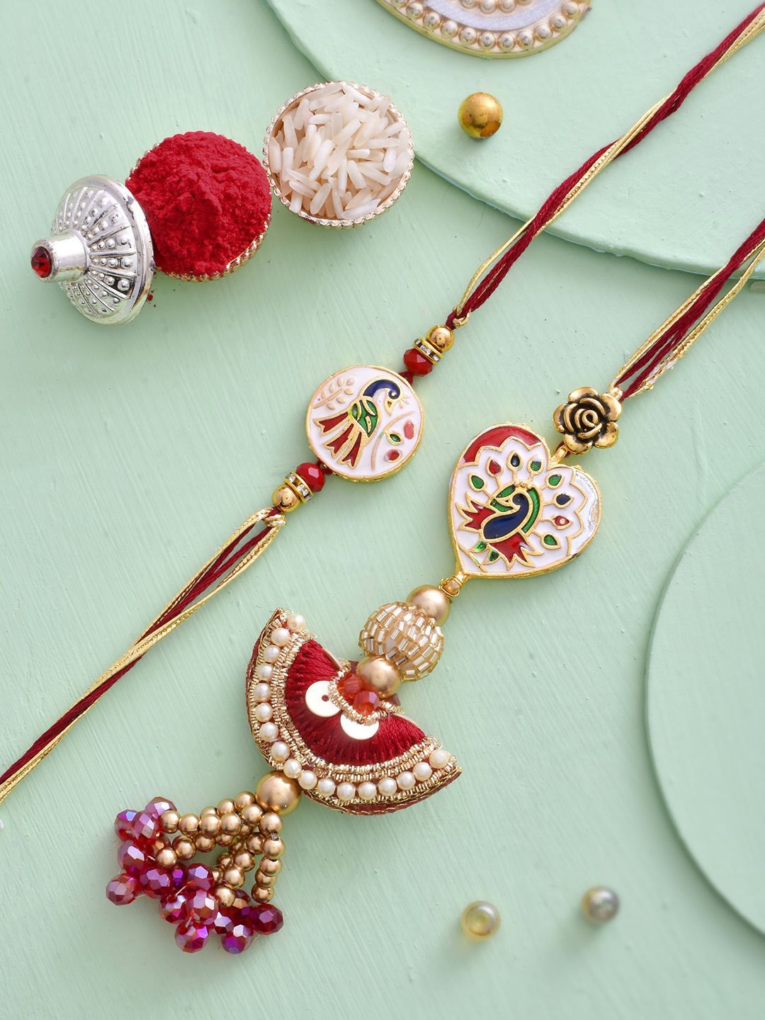 

Aapno Rajasthan Peacock Charm Beaded Bhaiya Bhabhi Thread Rakhis with Roli Chawal, Red