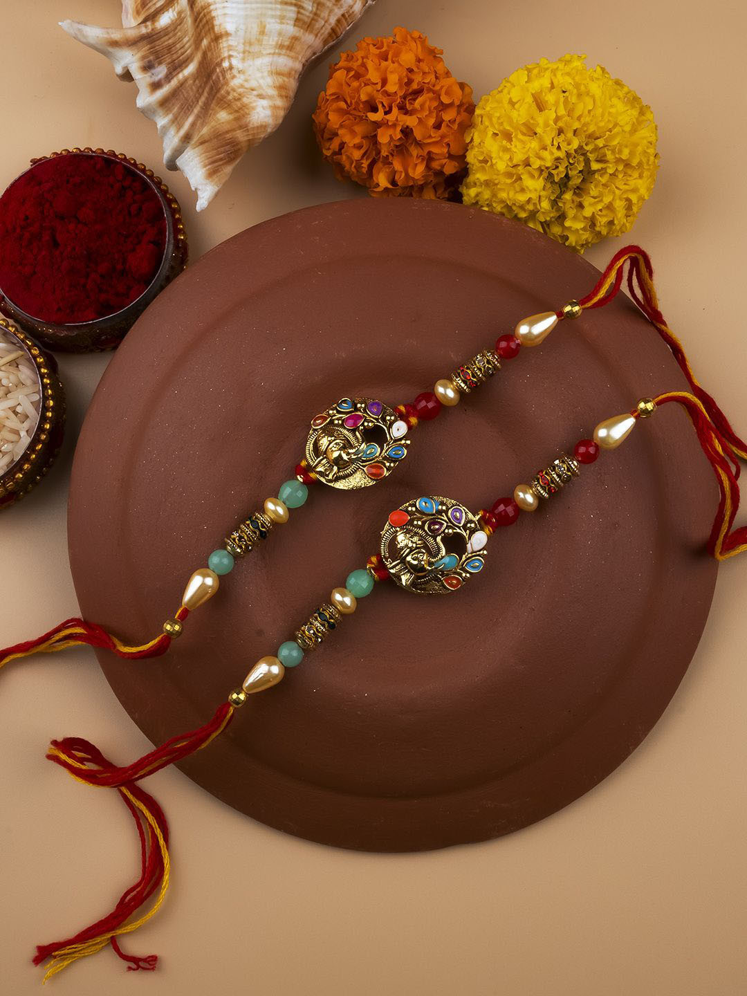

StileAdda Set Of 2 Beaded Thread Rakhis With Roli & Chawal With Chandan And Mishri, Red