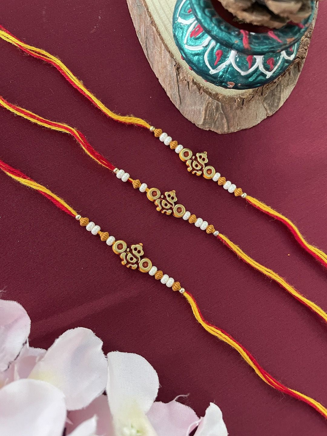 

Digital Dress Room Set Of 3 Pearls Beaded Lord Ganesha Rakhis, Gold