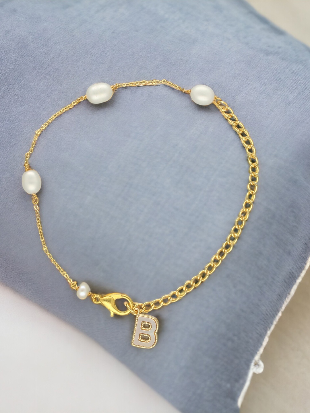 

Sri Jagdamba Pearls Dealer Gold-Plated Mother of Pearl Studded B Alphabet Charm Bracelet