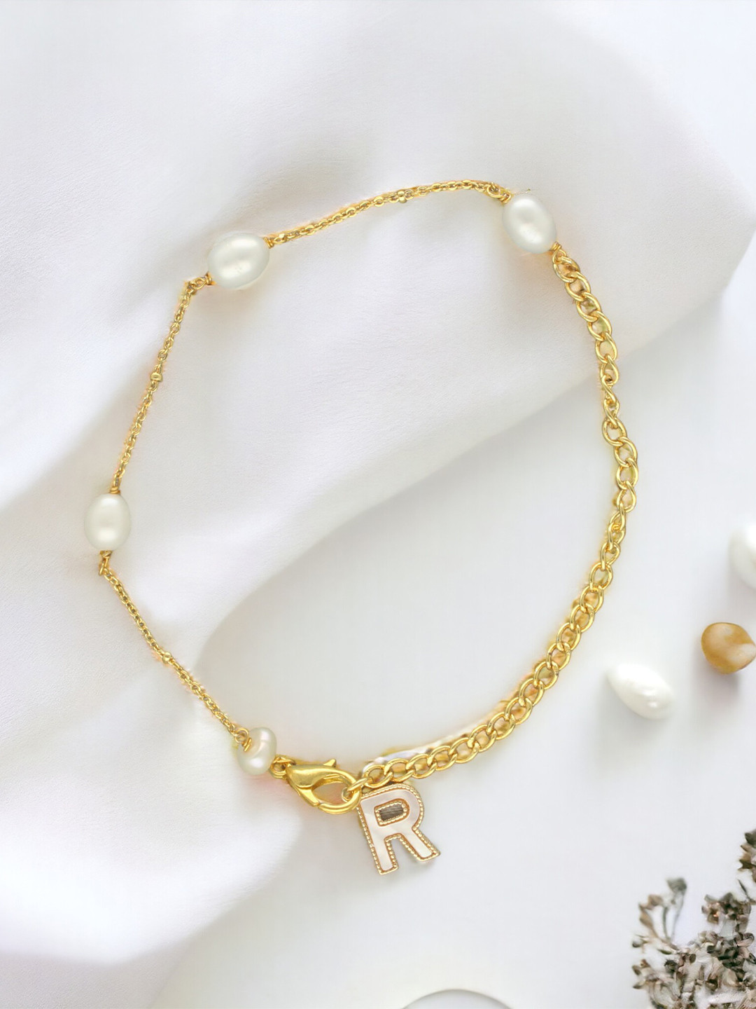 

Sri Jagdamba Pearls Dealer Gold-Plated Mother of Pearl Studded R Alphabet Charm Bracelet