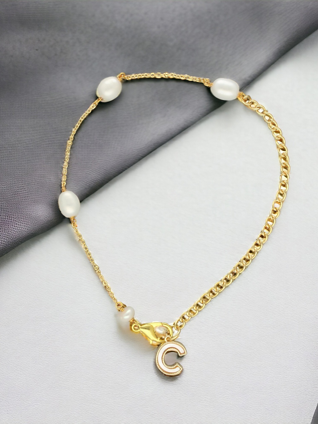 

Sri Jagdamba Pearls Dealer Gold-Plated Mother of Pearl Studded C Alphabet Charm Bracelet