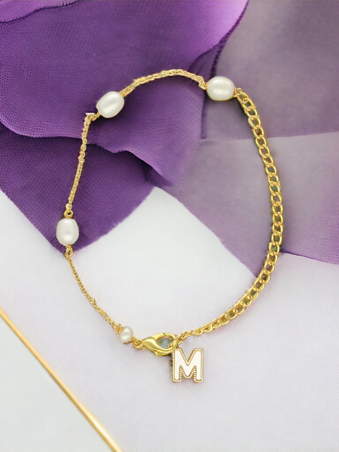 

Sri Jagdamba Pearls Dealer Gold-Plated Mother of Pearl Studded M Alphabet Charm Bracelet