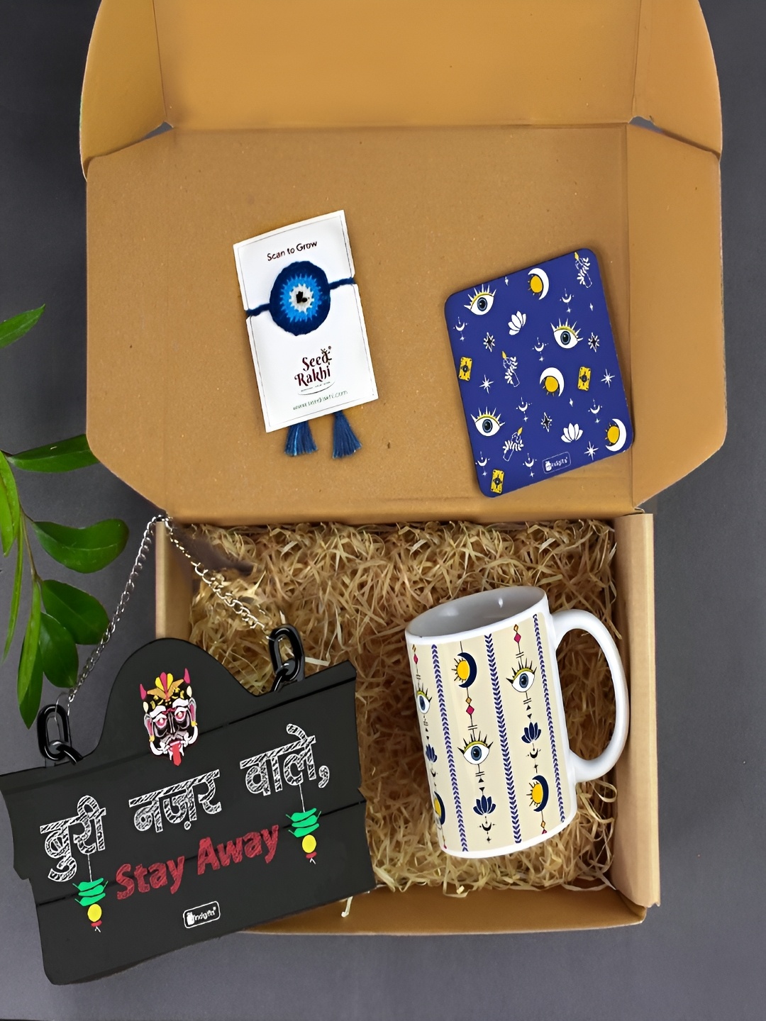 

Indigifts Set Of 4 Plantable Seed Rakhi With Coffee Mug Coaster And Wall Hanging, Blue