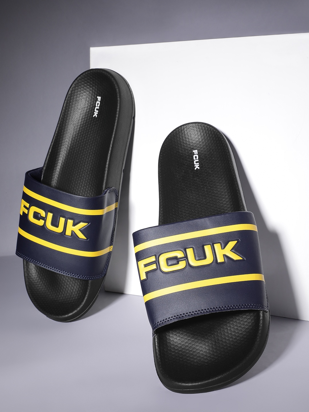 

FCUK Men Brand Logo Printed Textured Sliders, Navy blue