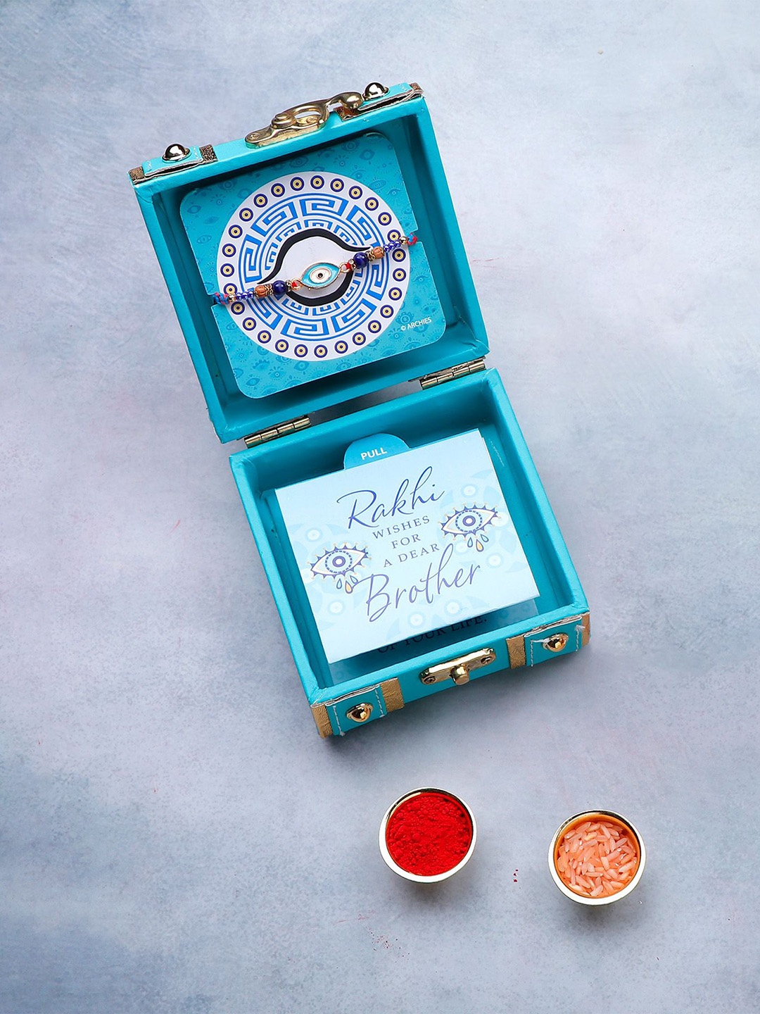 

Archies Evil Eye Beaded Rakhi in Trunk Box With Roli Chawal & Greeting Card, Sea green