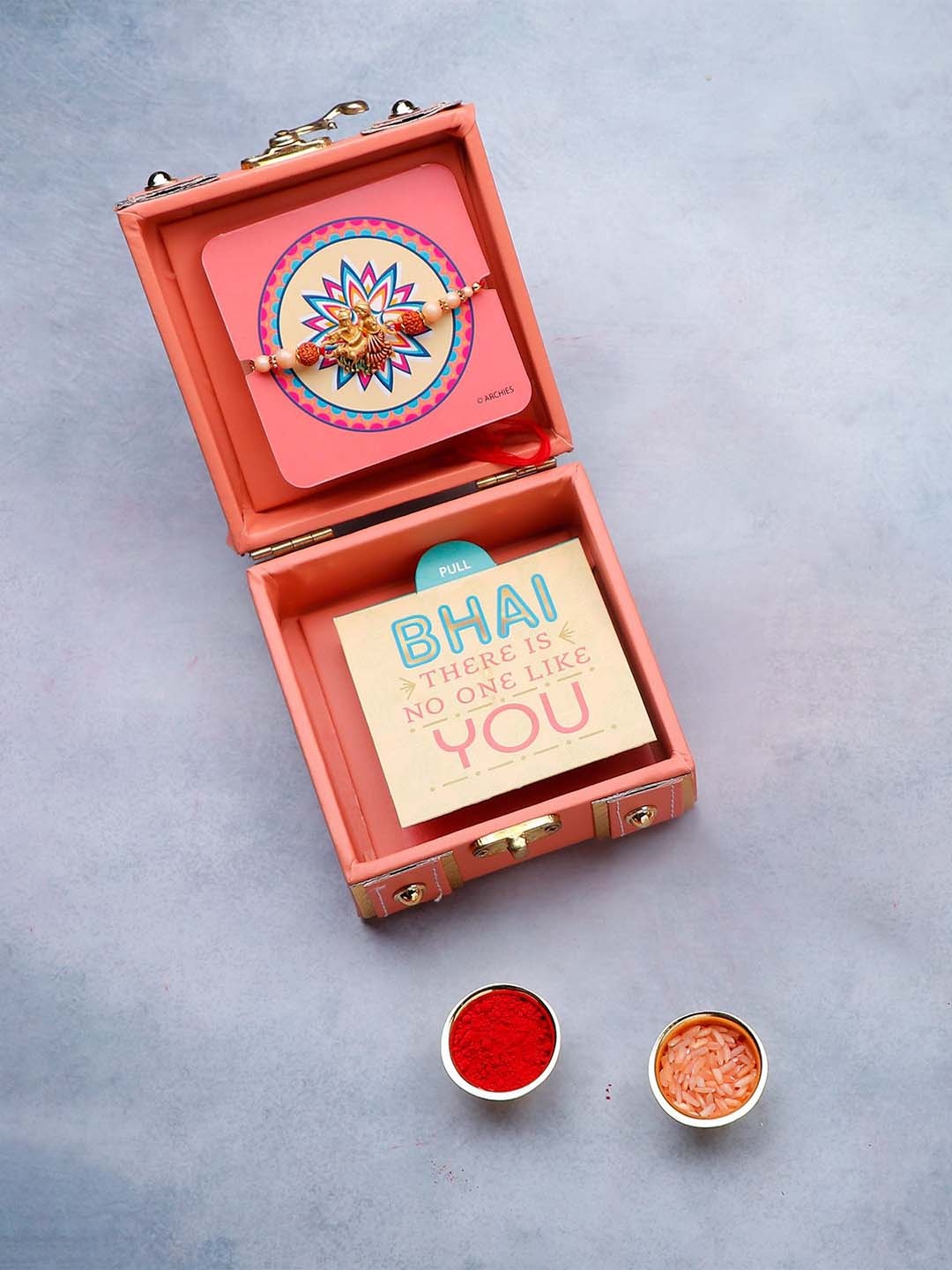 

Archies Divine Rudraksha Thread Rakhi in Trunk Box With Roli Chawal & Greeting Card, Coral