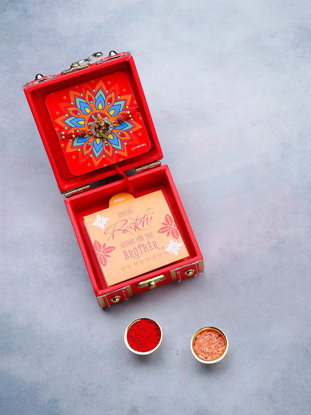 

Archies Shree Krishna Thread Rakhi in Trunk Box With Roli Chawal & Greeting Card, Red