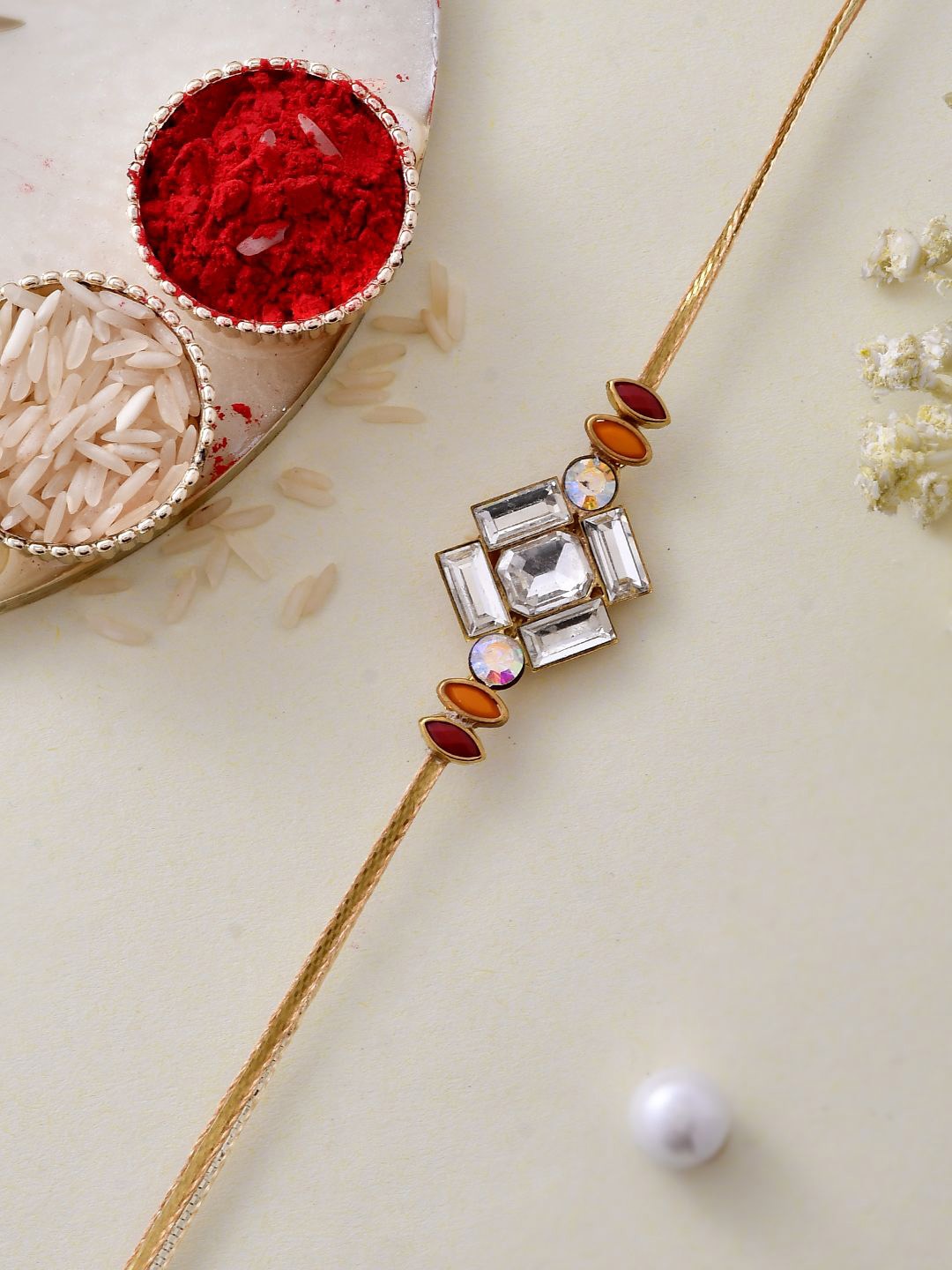 

Anouk Gold Toned American Diamond Stone Studded Rakhi With Roli Chawal & Greeting Card