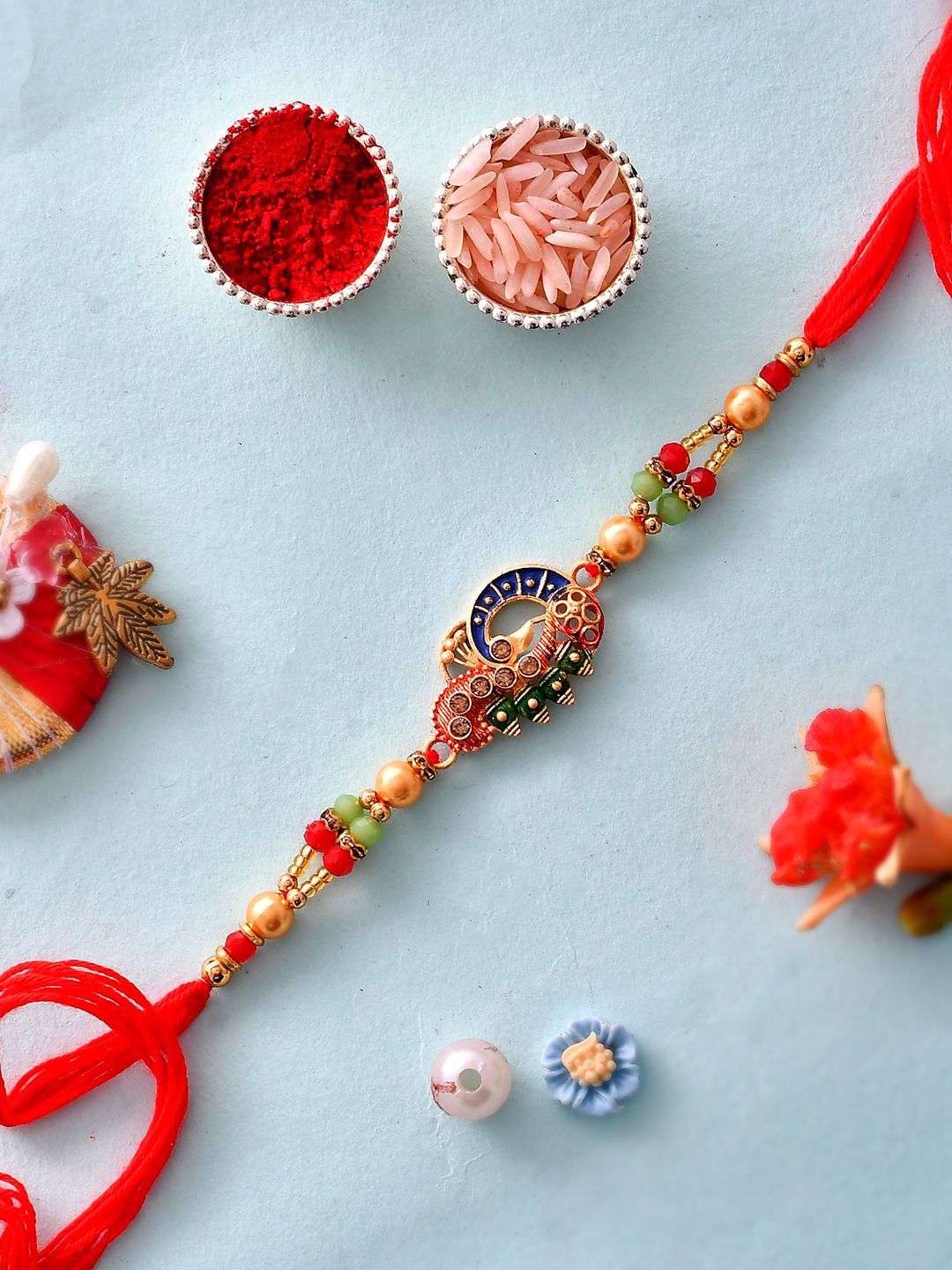 

Anouk Red Stone Studded & Beaded Thread Rakhi With Roli Chawal & Greeting Card, Gold