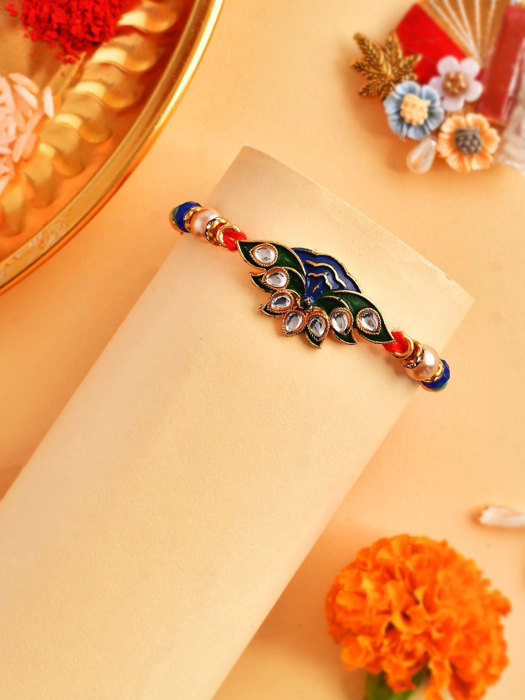 

Anouk Blue Peacock Enamled Beaded Rakhi With Roli Chawal & Greeting Card