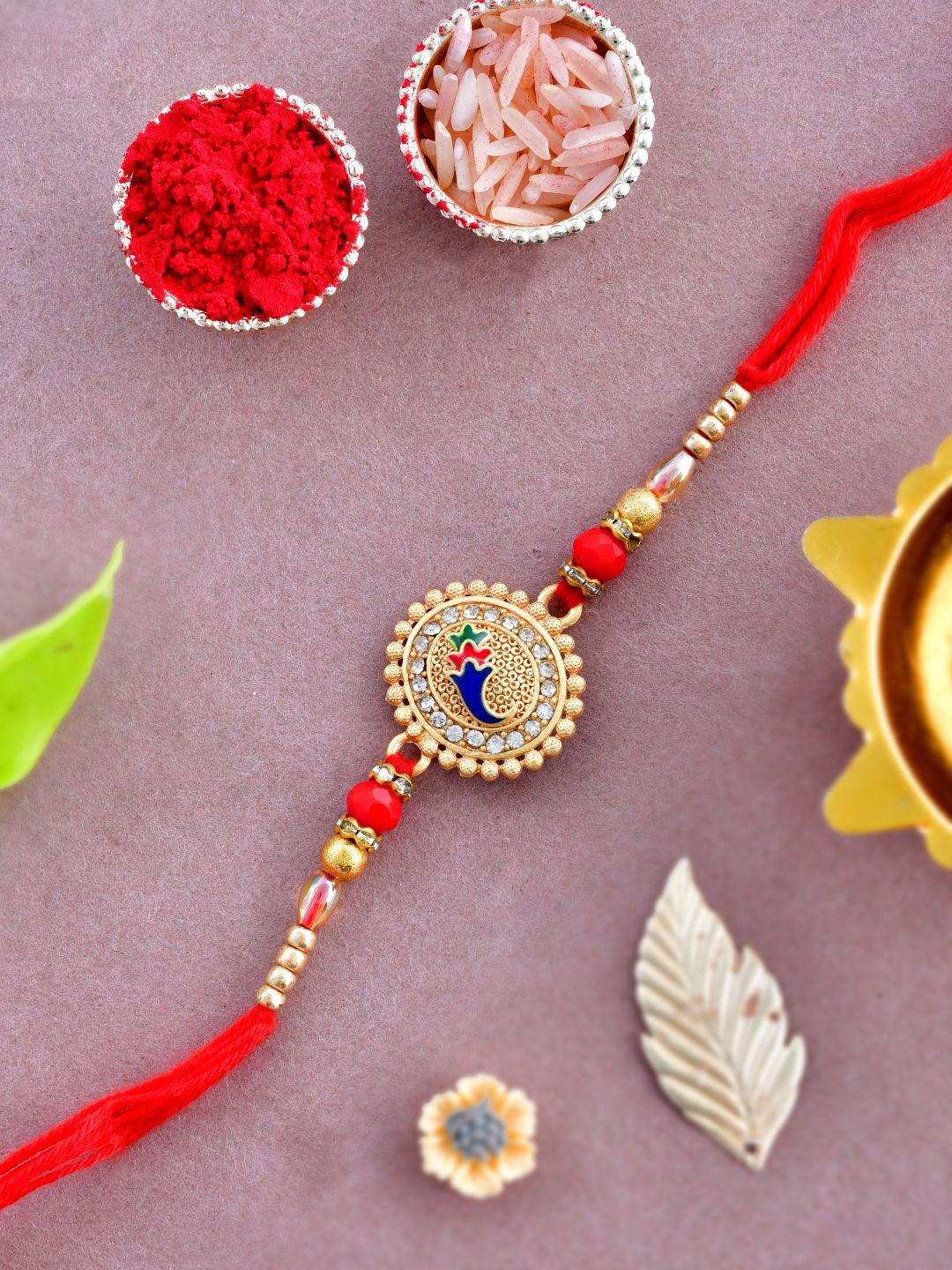 

Anouk Gold-Toned Stone-Studded & Beaded Rakhi With Roli Chawal & Greeting Card