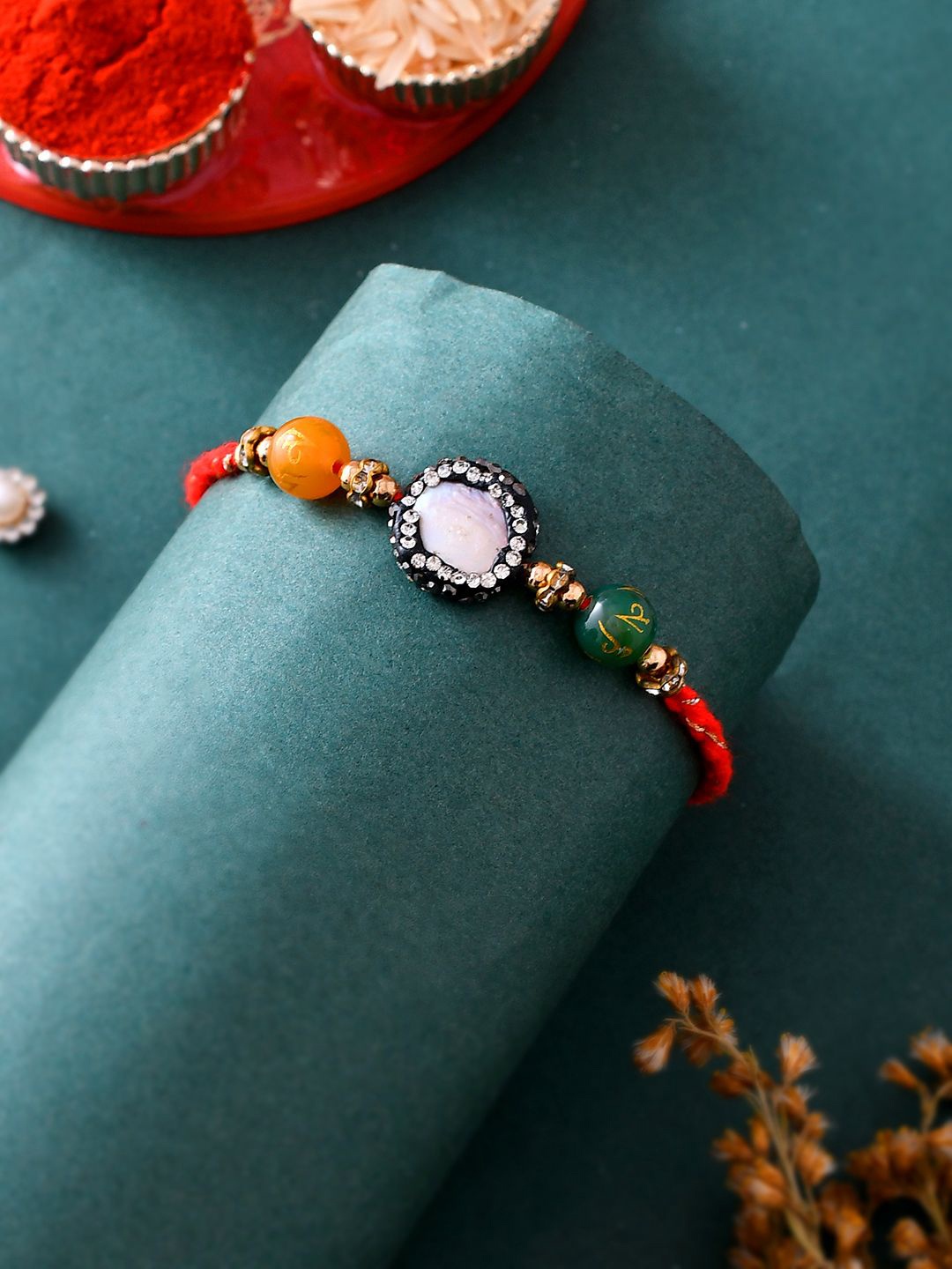 

Anouk Orange Stone Studded & Beaded Thread Rakhi With Roli Chawal & Greeting Card, Green