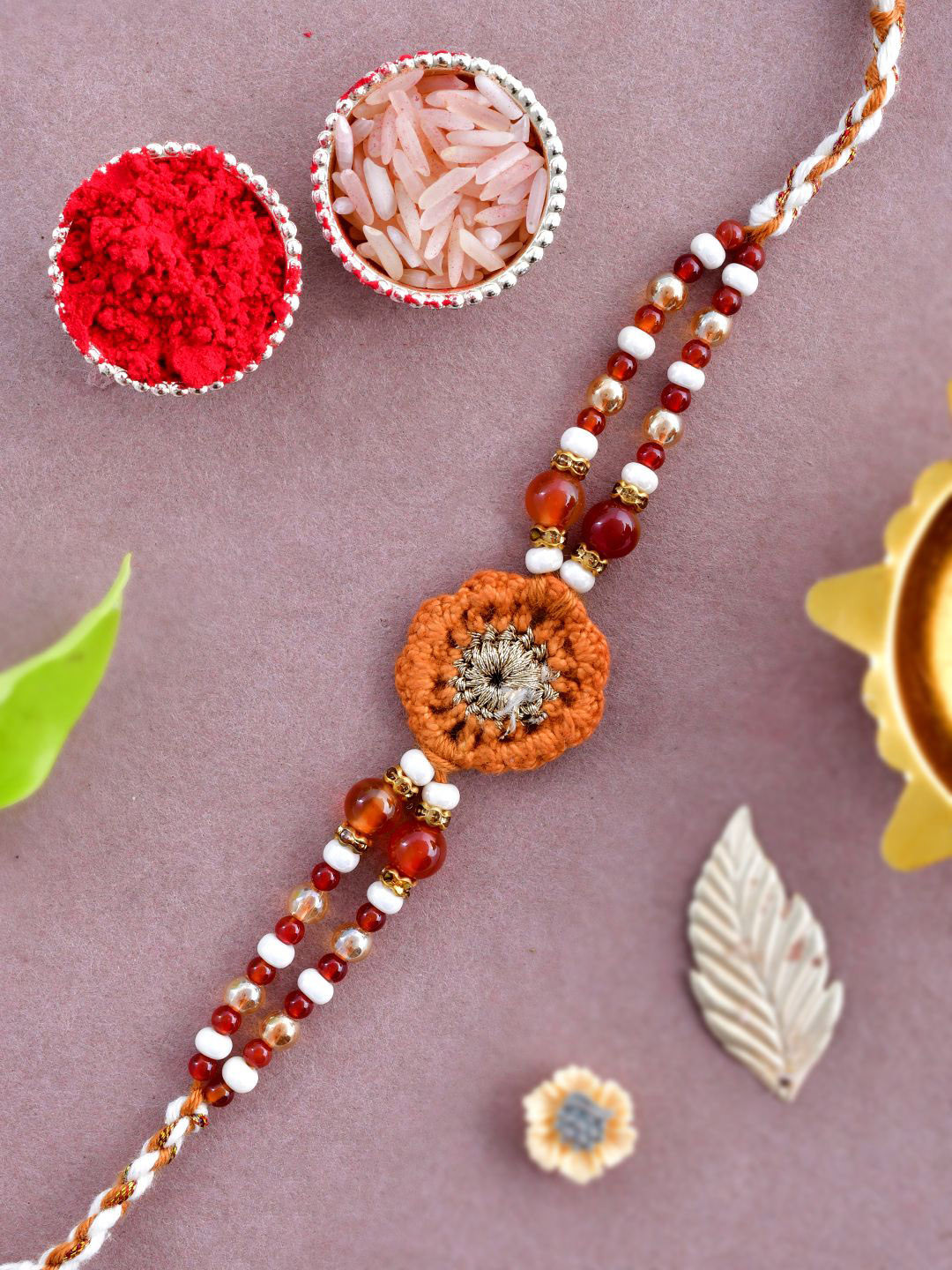 

Anouk Brown Wool Knitted & Beaded Rakhi With Roli Chawal & Greeting Card