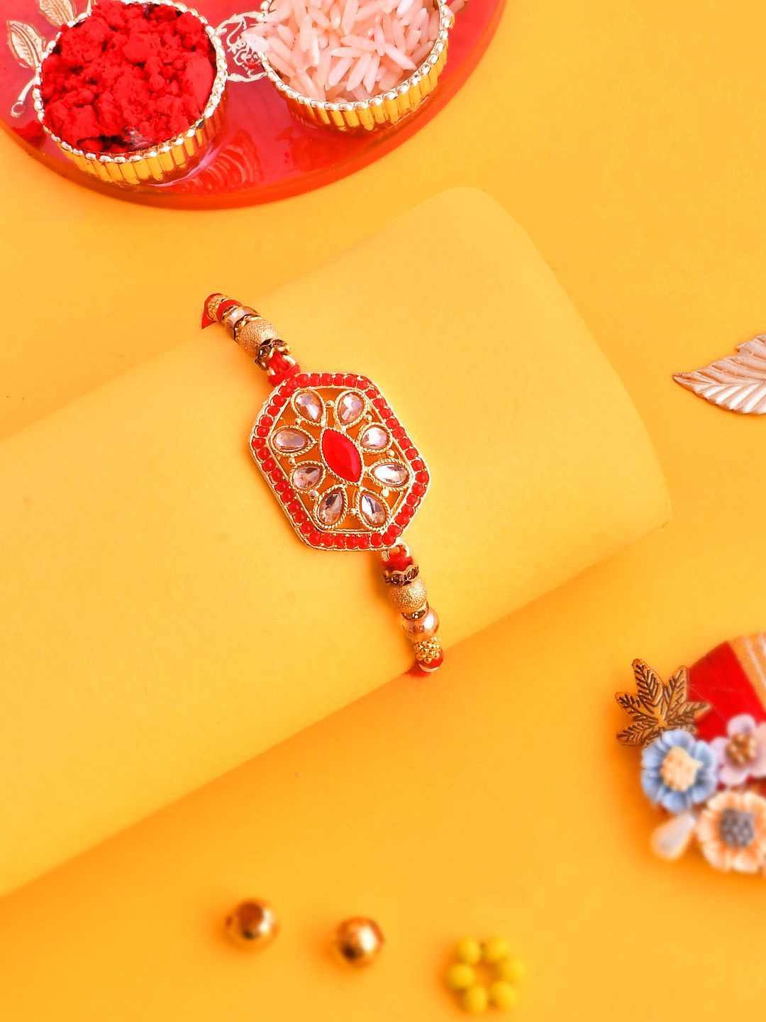 

Anouk Gold-Toned Beaded Rakhi With Roli Chawal & Greeting Card