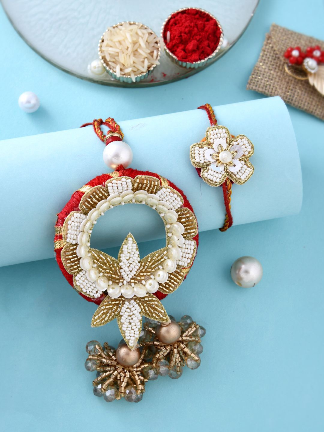 

Anouk Gold-Toned Pearl-Beaded Bhaiya Bhabhi Rakhi With Roli Chawal & Greeting Card