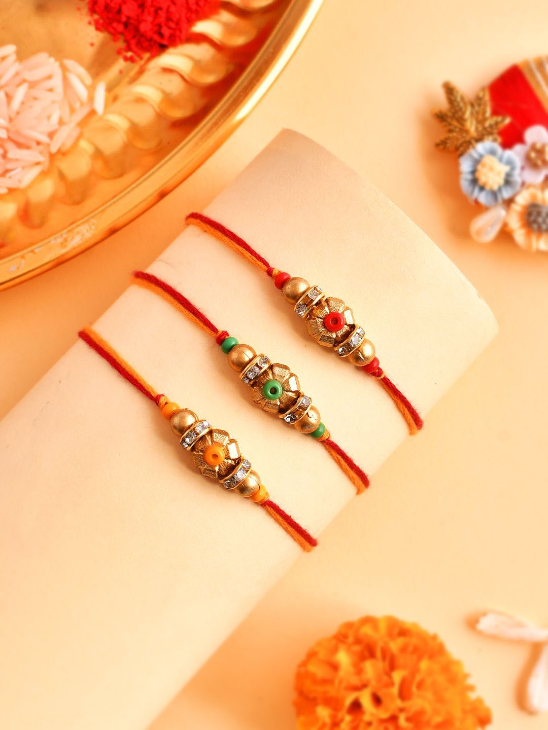 

Anouk Set Of 3 Gold-Toned Beaded Rakhi With Roli Rice & Greeting Card