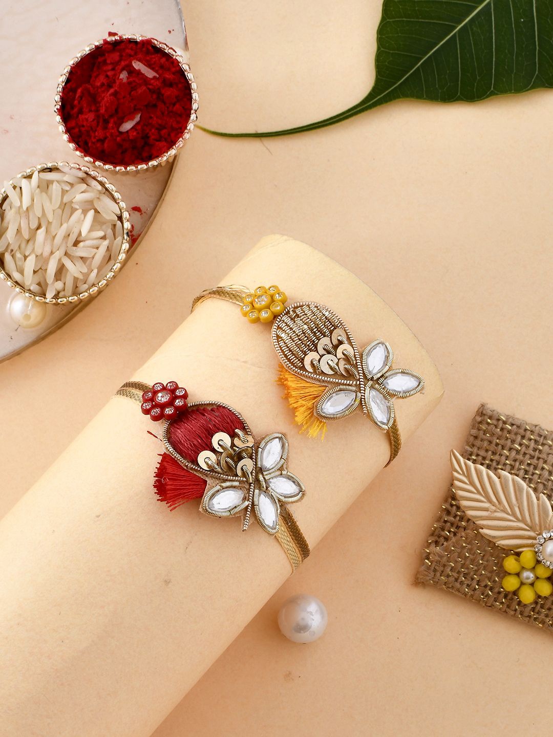 

Anouk Gold Toned Set Of 2 Kundan Thread Rakhis With Roli, Chawal & Greeting Card, Red