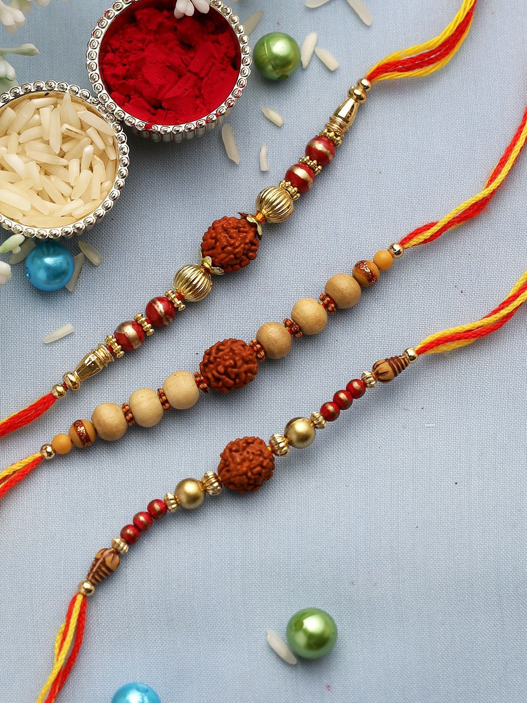 

Anouk Set Of 3 Brown Rudraksh And Sandalwood Beaded Rakhi With Roli Rice & Greeting Card