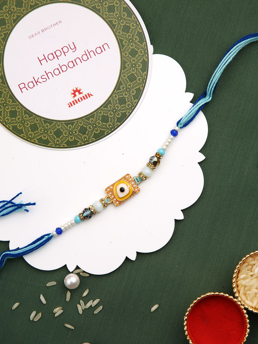 

Anouk Beaded Evil Eye Rakhi With Roli Chawal & Greeting Card, Blue