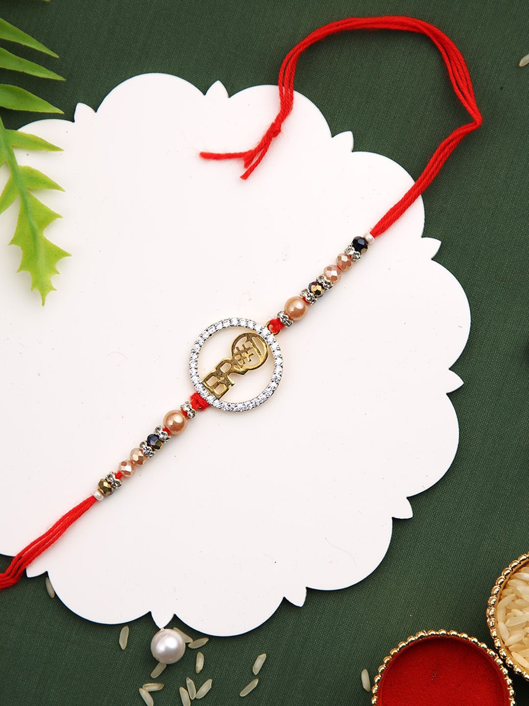 

Anouk Red Stone Studded & Beaded Thread Rakhi With Roli Chawal & Greeting Card, Gold