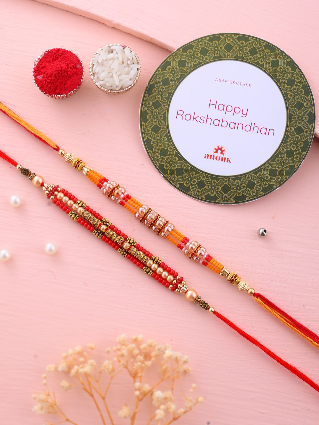 

Anouk Set Of 2 Red Beaded Rakhi With Roli Rice & Greeting Card
