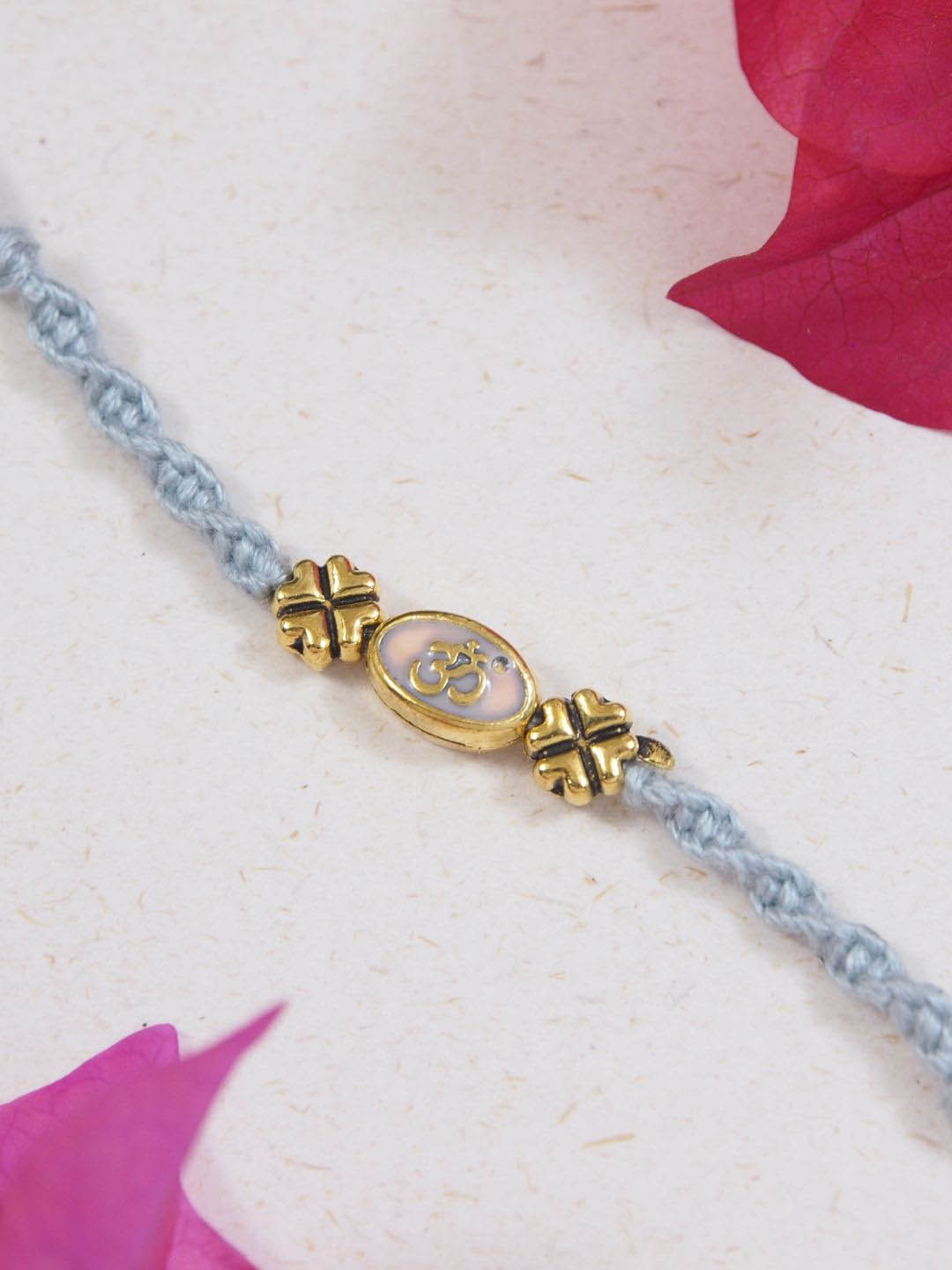 

I Jewels OM Thread Rakhi With Roli Chawal & Greeting Card, Grey