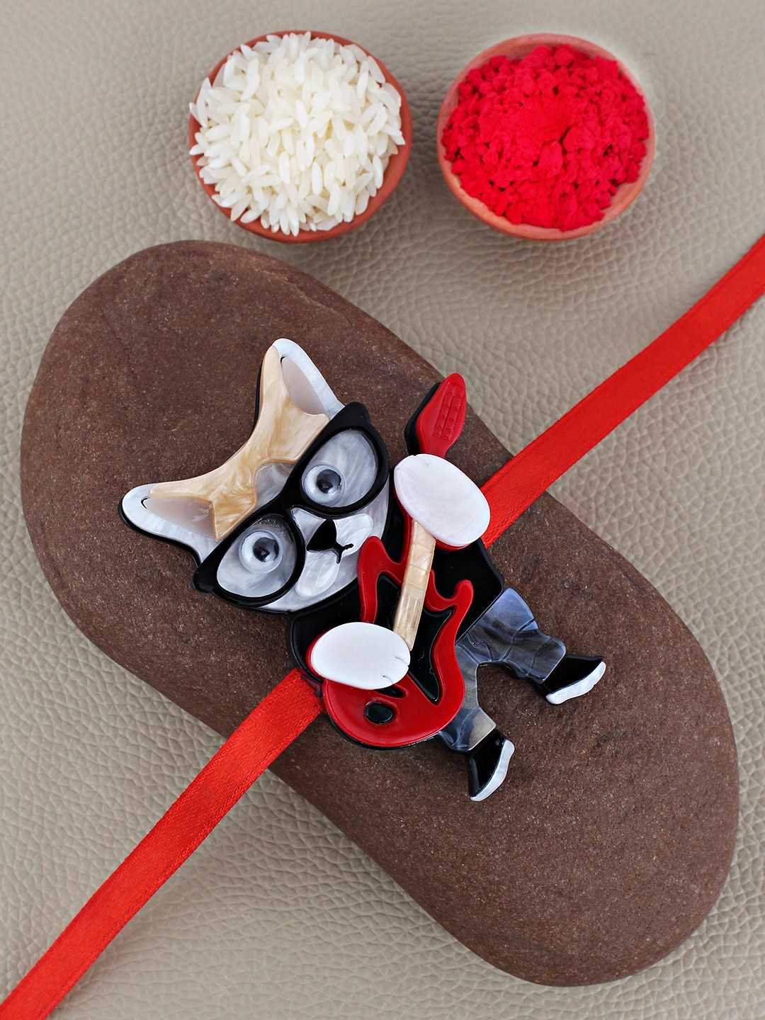 

LUCKY JEWELLERY Guitar Cat With Glasses Thread Rakhi With Roli Chawal & Greeting Cards, Red